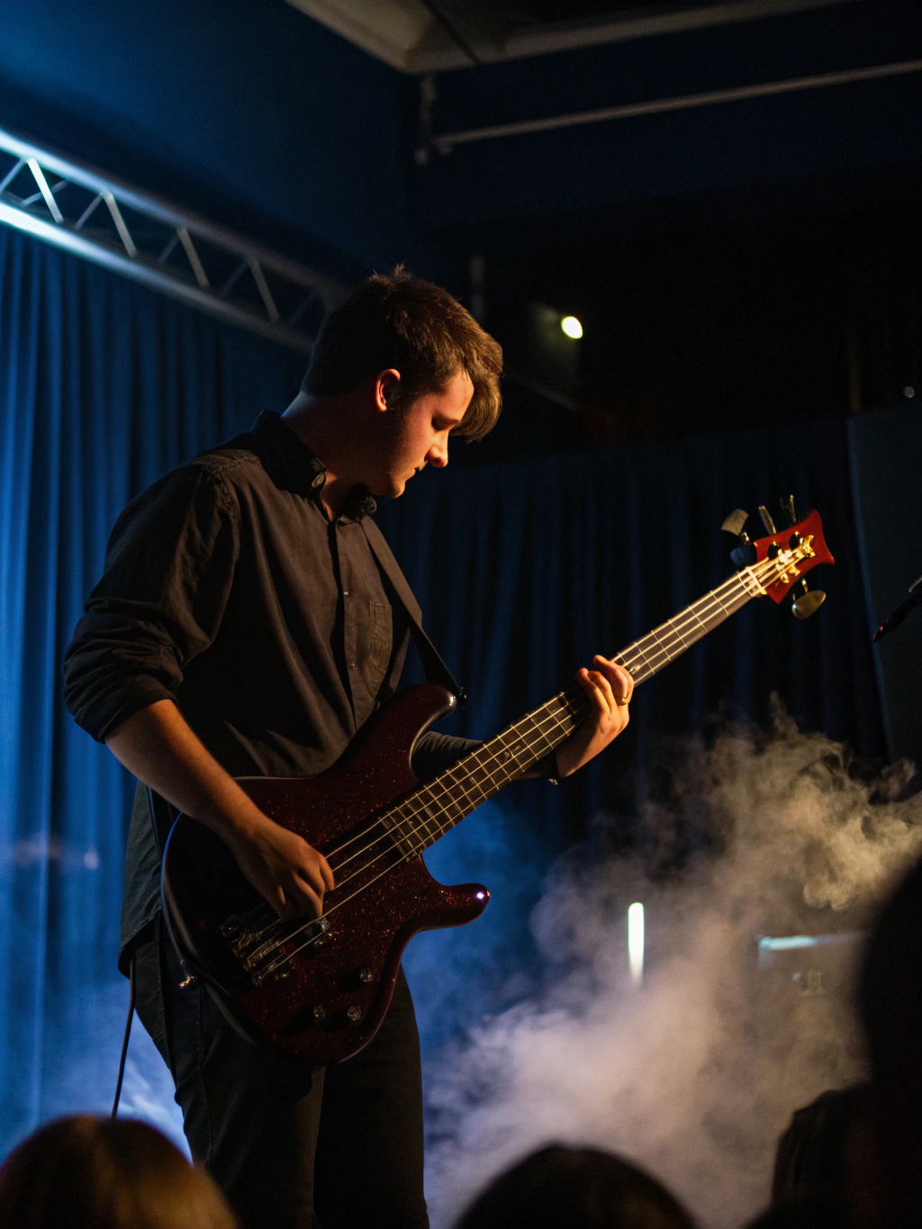 Silhouette of a bass player against a bright light